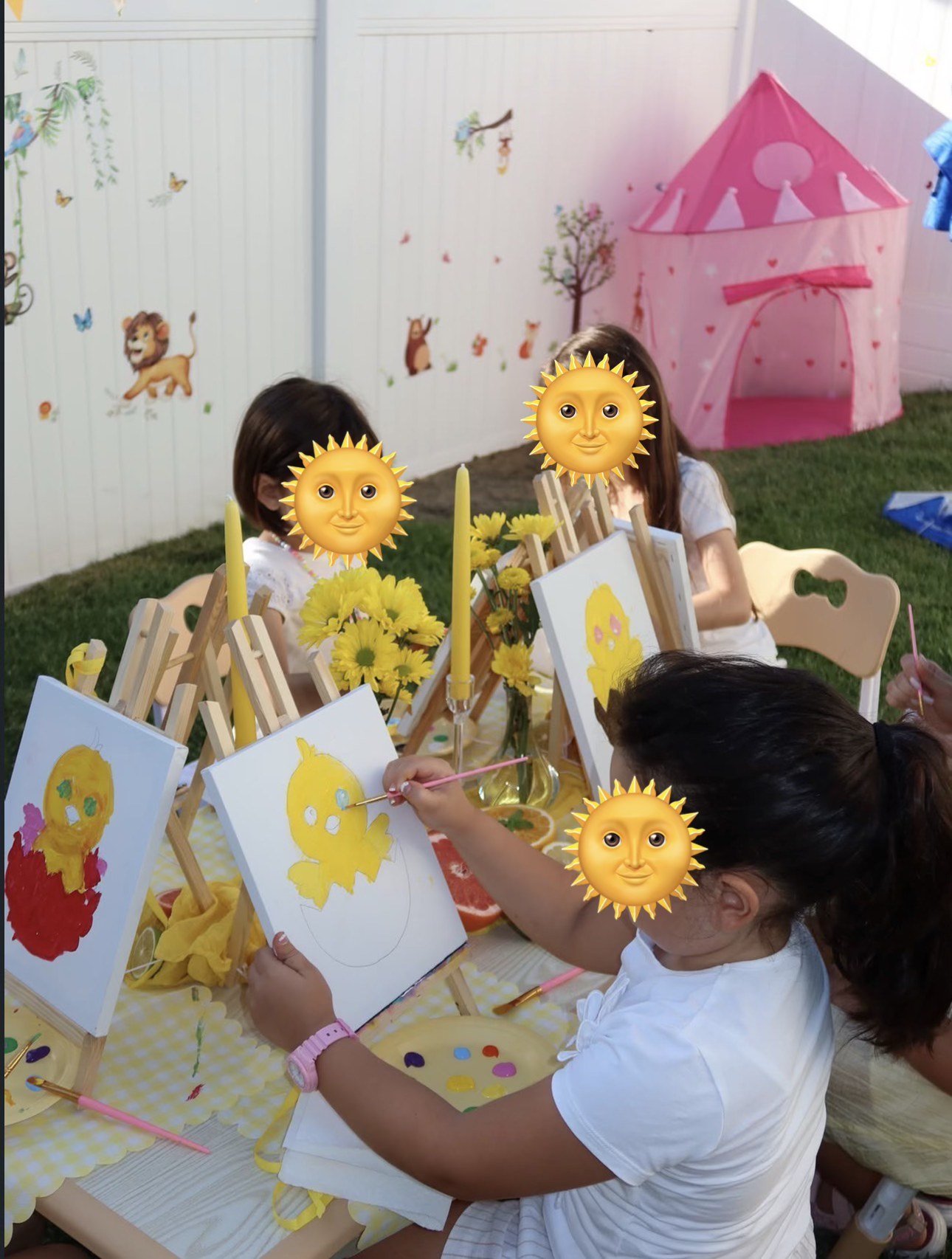 Children painting together in the Top-Top outdoor play area