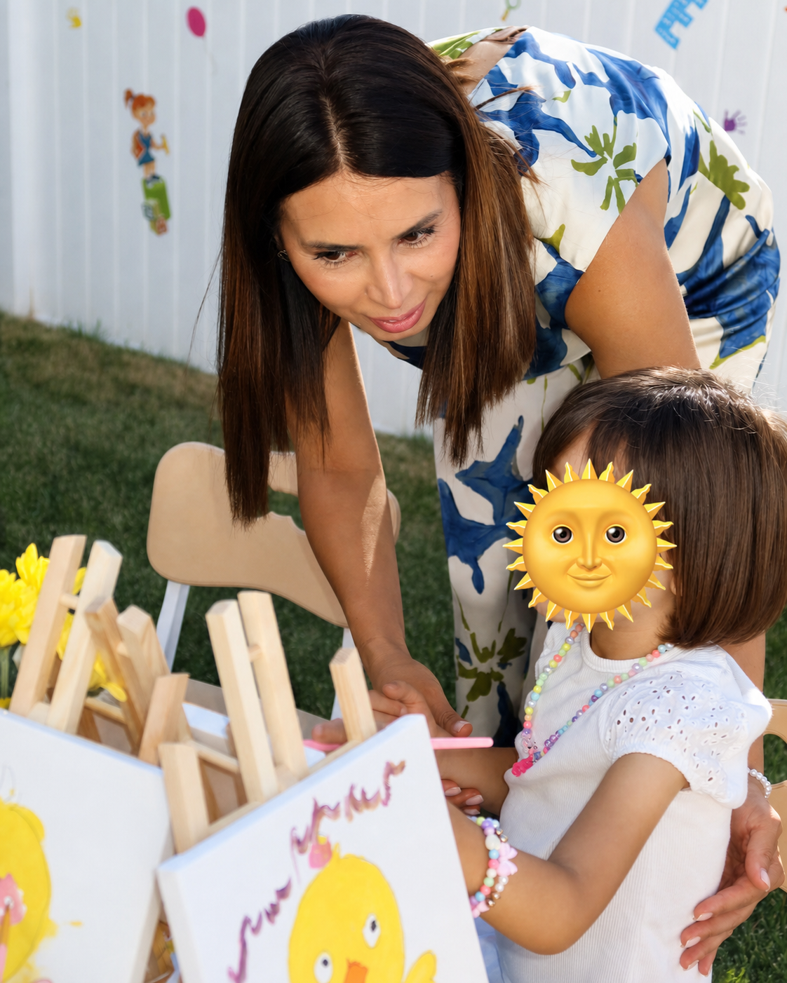 Kristine Manukyan helping a child during a painting activity