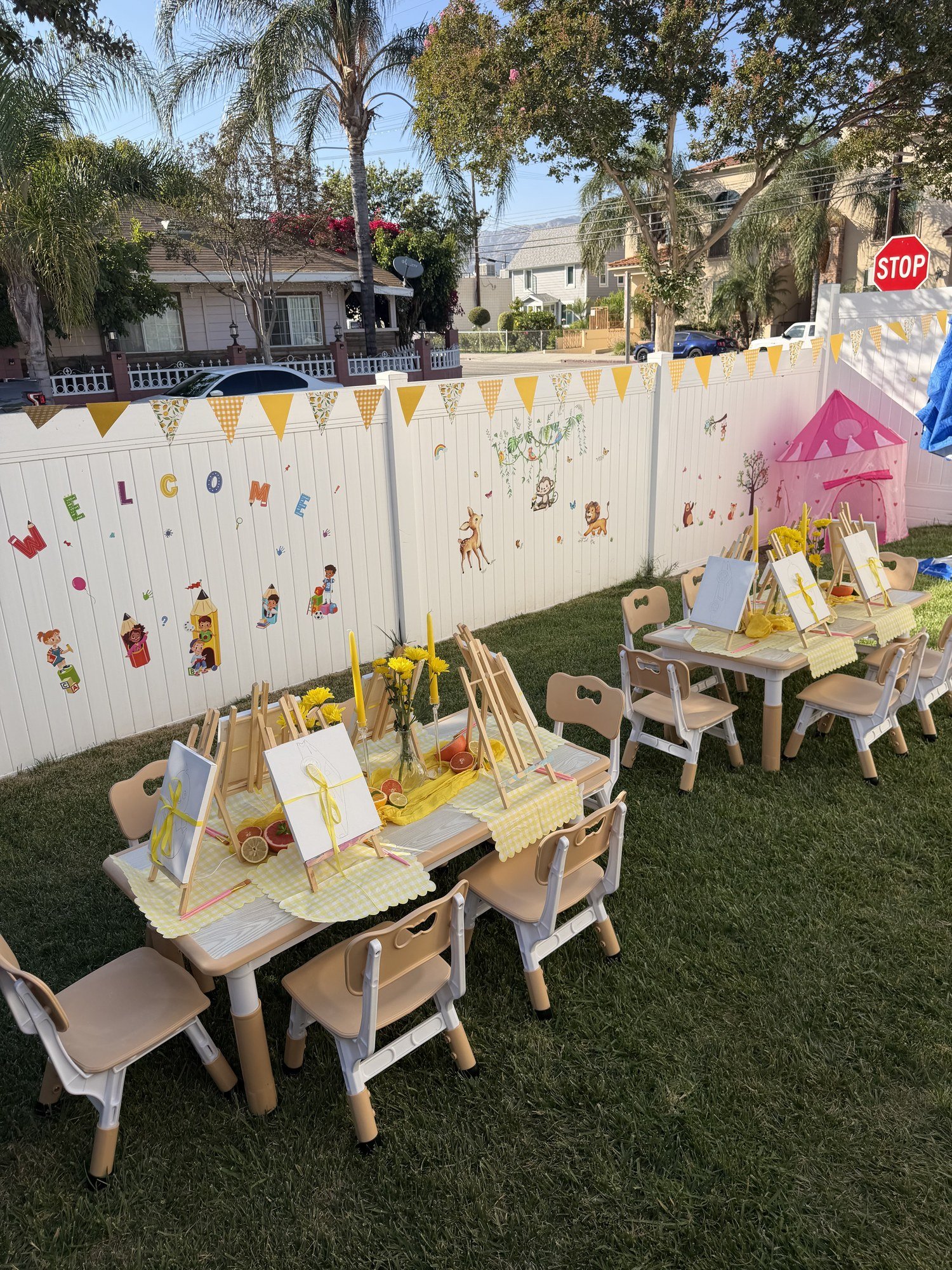 Top-Top Day Care backyard with child-sized activity tables, chairs, and easels